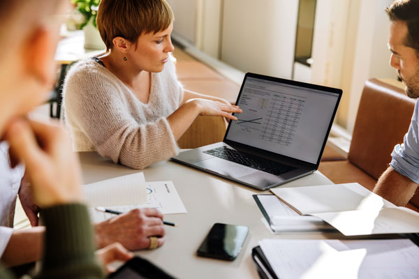 Image of a woman showing a presentation on her laptop