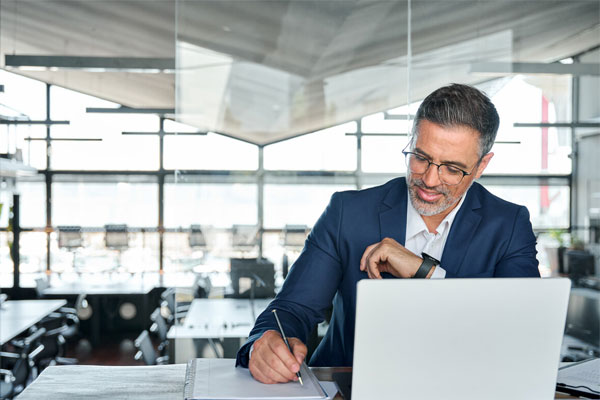 Image of a man working on his laptop