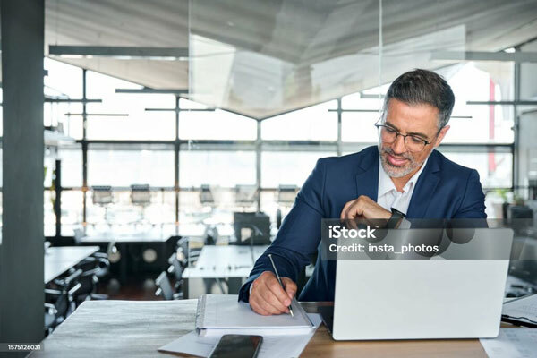 Image of a man working on his laptop